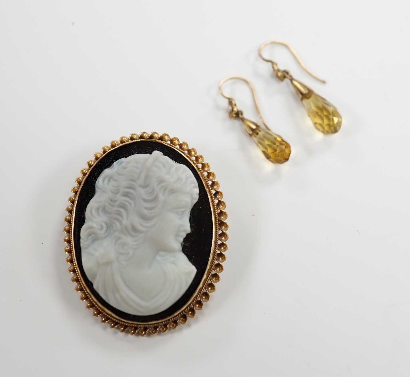 A modern 9ct gold mounted sardonyx? cameo set pendant brooch, 39mm and a pair of gem set drop earrings.